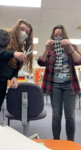 students showing scissors and cut necktie