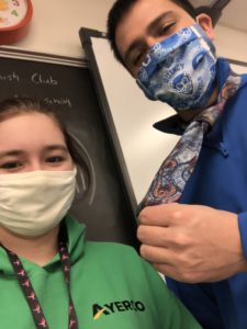 student standing next to teacher with severed necktie